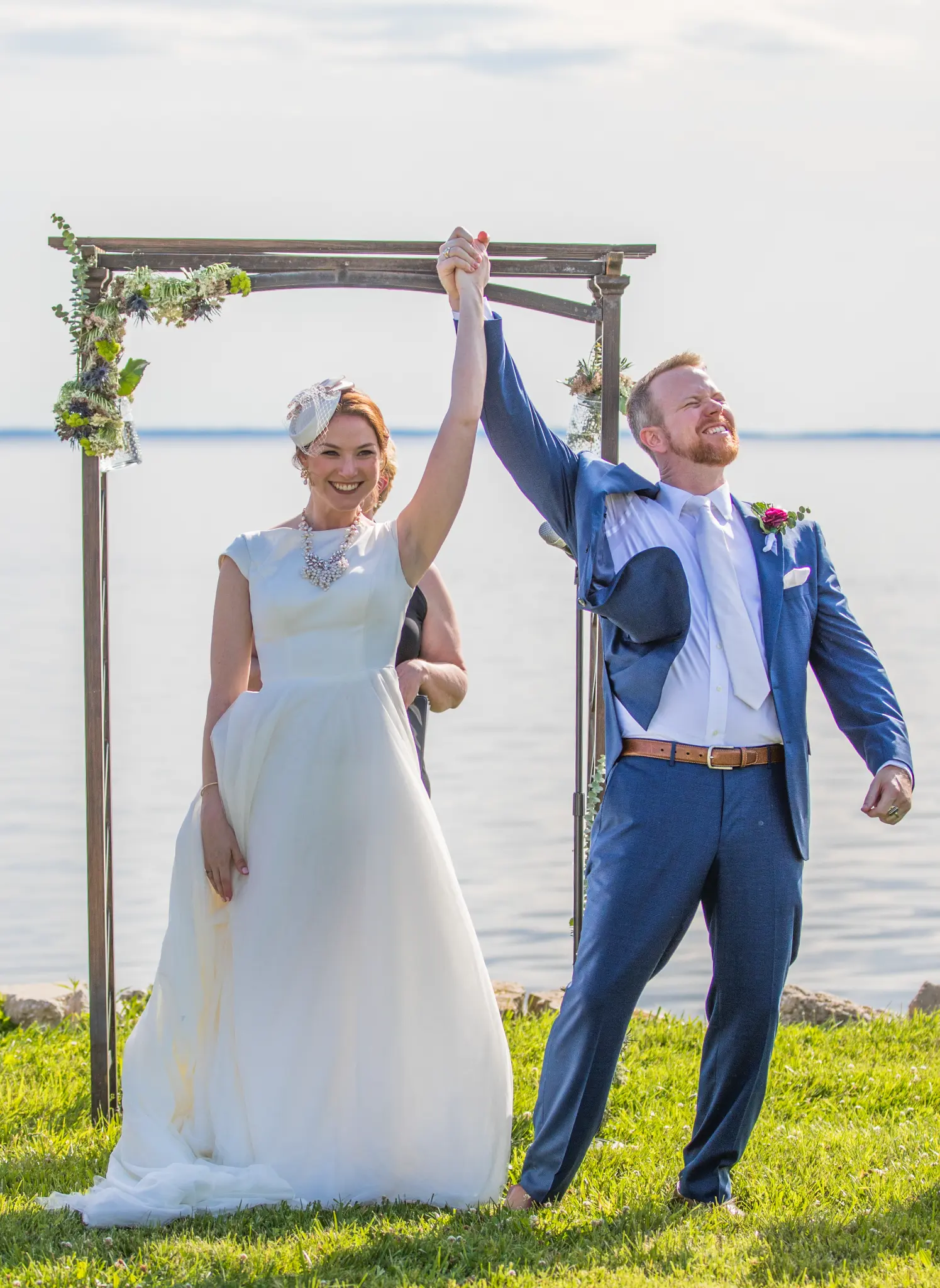 Couple raising hands in triumph at recessional