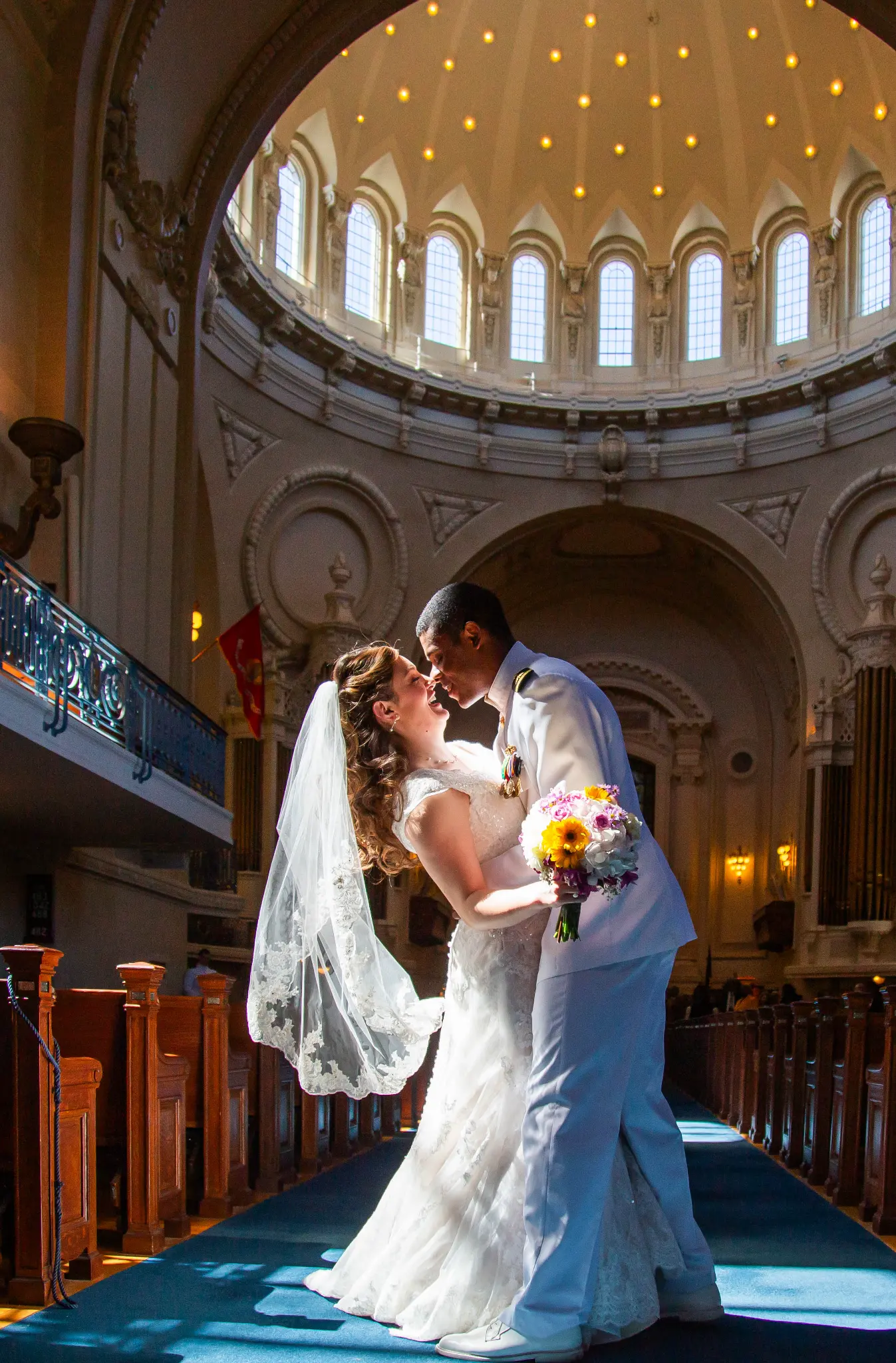 Interracial couple sharing an intimate moment inside the Naval Academy Chapel dome — Andrew Rozario wedding photographer
